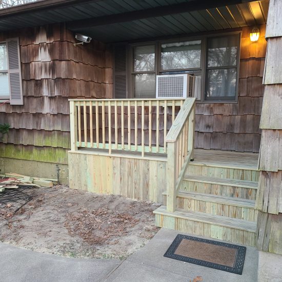 Wooden porch with steps and railing